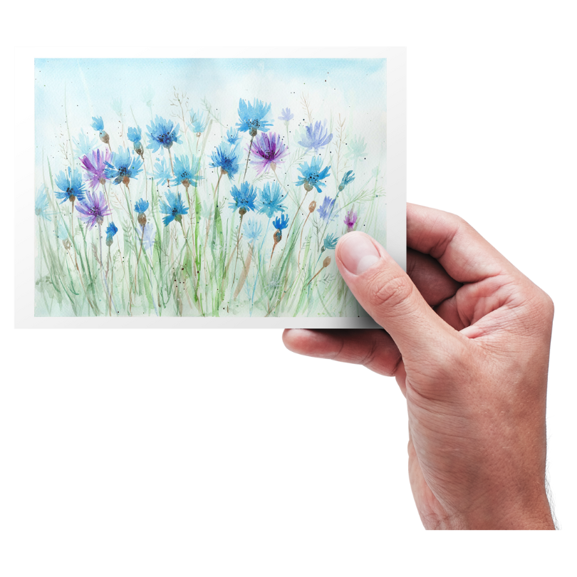 Hand holding a card with floral design on a white background