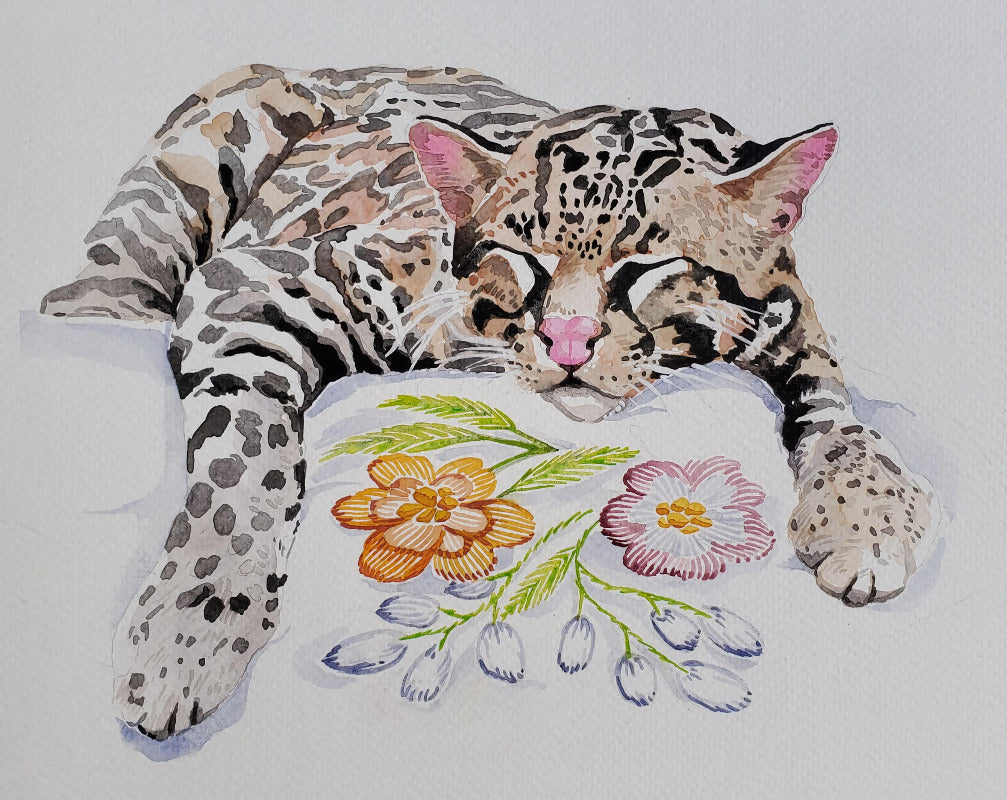 Sleeping ocelot next to a floral design on a white background
