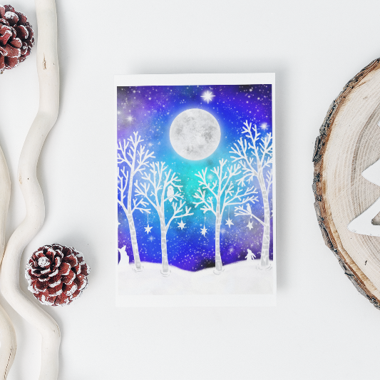 Framed artwork of a winter scene with trees and moon, surrounded by decorative elements on a white background.