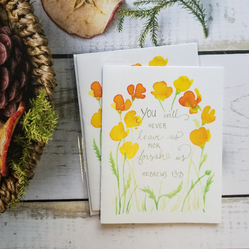 Floral card with inspirational message on a rustic wooden surface