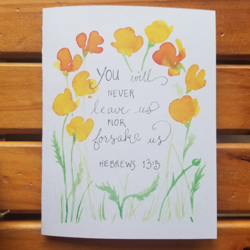 Card with yellow flowers and Bible verse on a wooden background