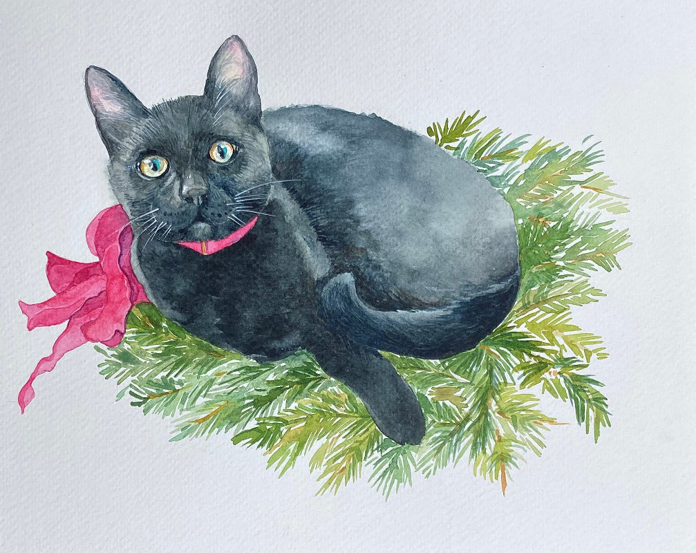 Black cat with a pink bow on a branch with green leaves