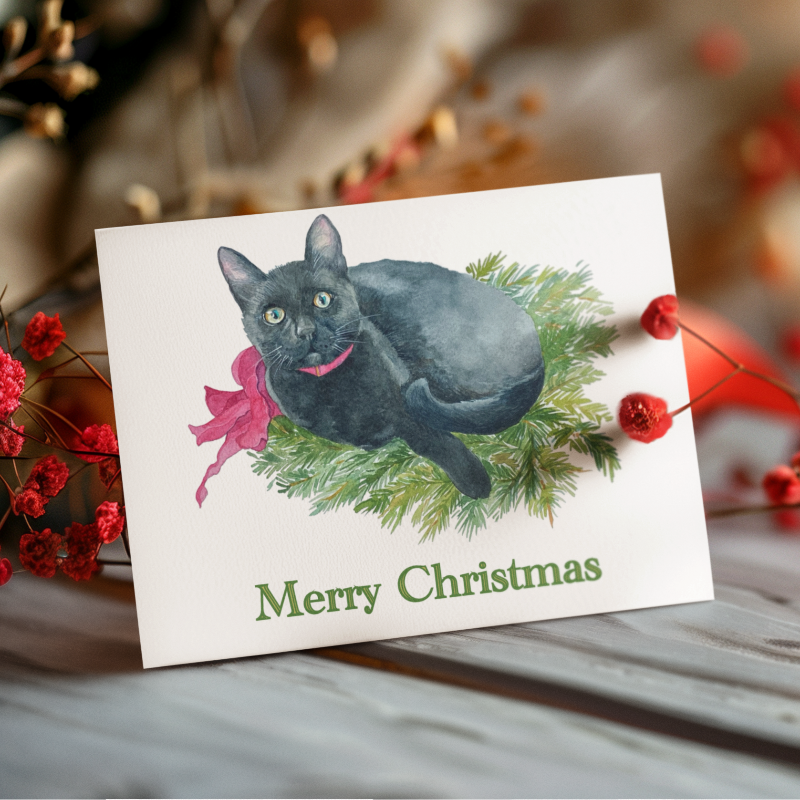 Christmas card with a black cat illustration on a wooden surface with red berries and a candle.