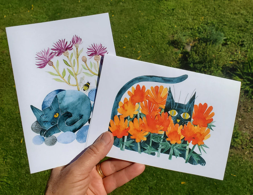 folk art style whimsical black cats in the flowers